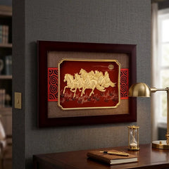 Decorative wall art with horses in a wooden frame on a gray wall above a desk.