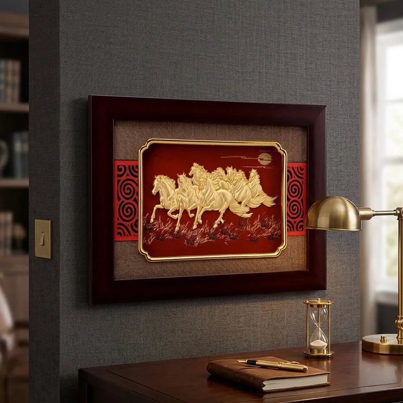 Decorative wall art with horses in a wooden frame on a gray wall above a desk.
