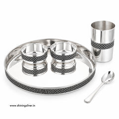 Shining Silver, A silver-toned stainless steel tea or coffee cup set on a white background, including a large oval tray, a tall cup, two small bowls, and a spoon. The pieces feature black geometric filigree detailing around the rims.
