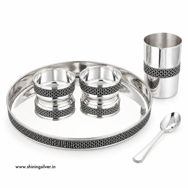 Shining Silver, A silver-toned stainless steel tea or coffee cup set on a white background, including a large oval tray, a tall cup, two small bowls, and a spoon. The pieces feature black geometric filigree detailing around the rims.
