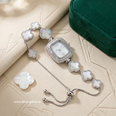 Silver watch with floral design on a textured surface, brand 'shiningsilver.in' visible
