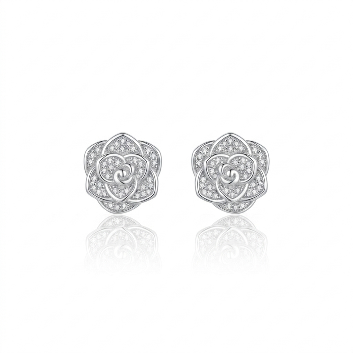 Pair of silver rose-shaped earrings with clear gemstones on a white background
