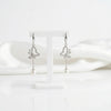 Butterfly-shaped earrings with pearl drops on a white background “shiningsilver.in”