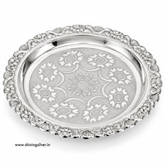 An ornate silver serving platter with a decorative floral pattern engraved on the center and a matching beaded border, shown on a white background with a website watermark.