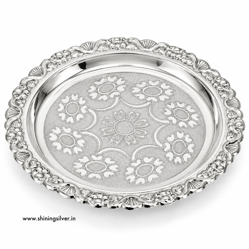 An ornate silver serving platter with a decorative floral pattern engraved on the center and a matching beaded border, shown on a white background with a website watermark.
