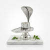 Silver Shiva jalheri shivling stand on a marble base with floral designs, brand 'Shining Silver' visible.