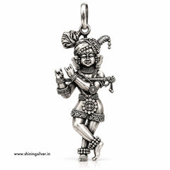 A detailed sterling silver pendant of a dancing Hindu deity, shown on a plain white background with a small website watermark in the bottom-left corner.