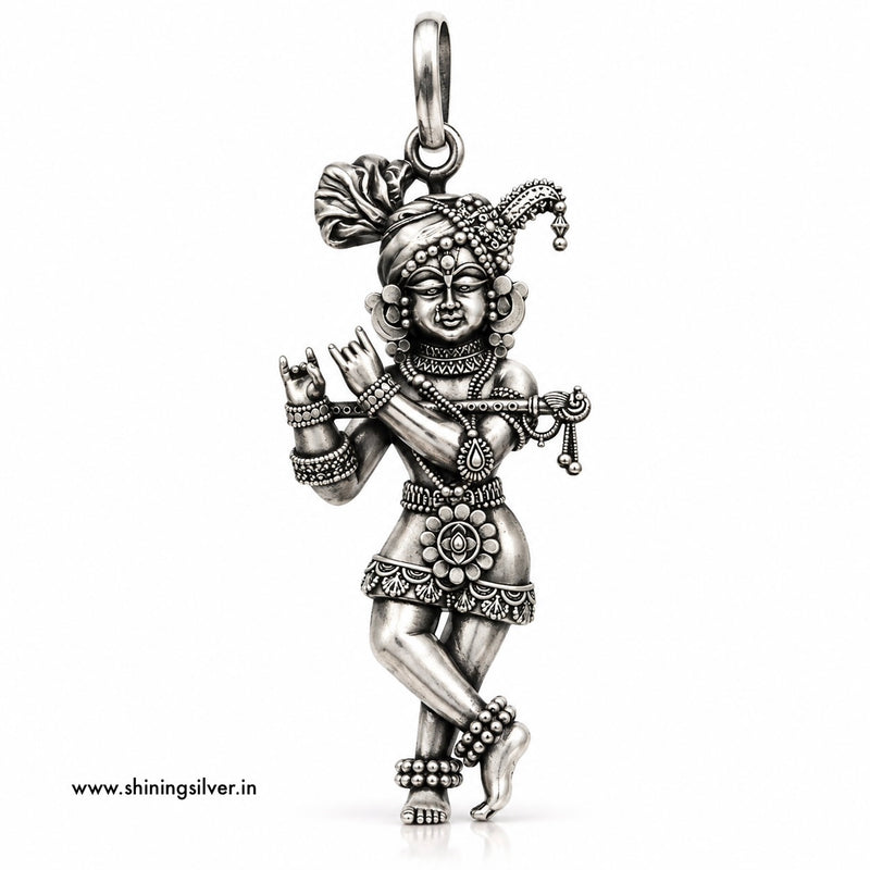 A detailed sterling silver pendant of a dancing Hindu deity, shown on a plain white background with a small website watermark in the bottom-left corner.