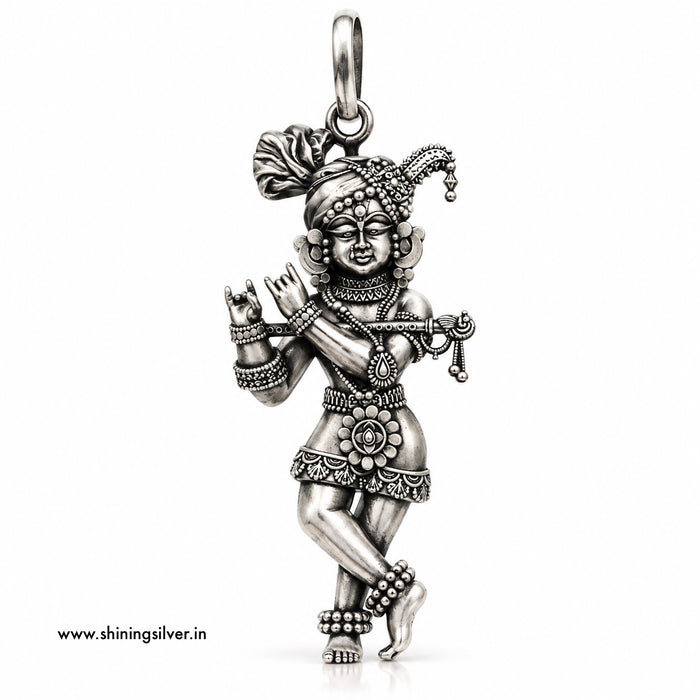 A detailed sterling silver pendant of a dancing Hindu deity, shown on a plain white background with a small website watermark in the bottom-left corner.