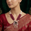 Woman wearing a maroon saree with a shrinath ji detailed necklace, brand 'Shining Silver' visible.