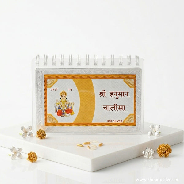 Silver idol of Lord Hanuman in a decorative frame on a white background